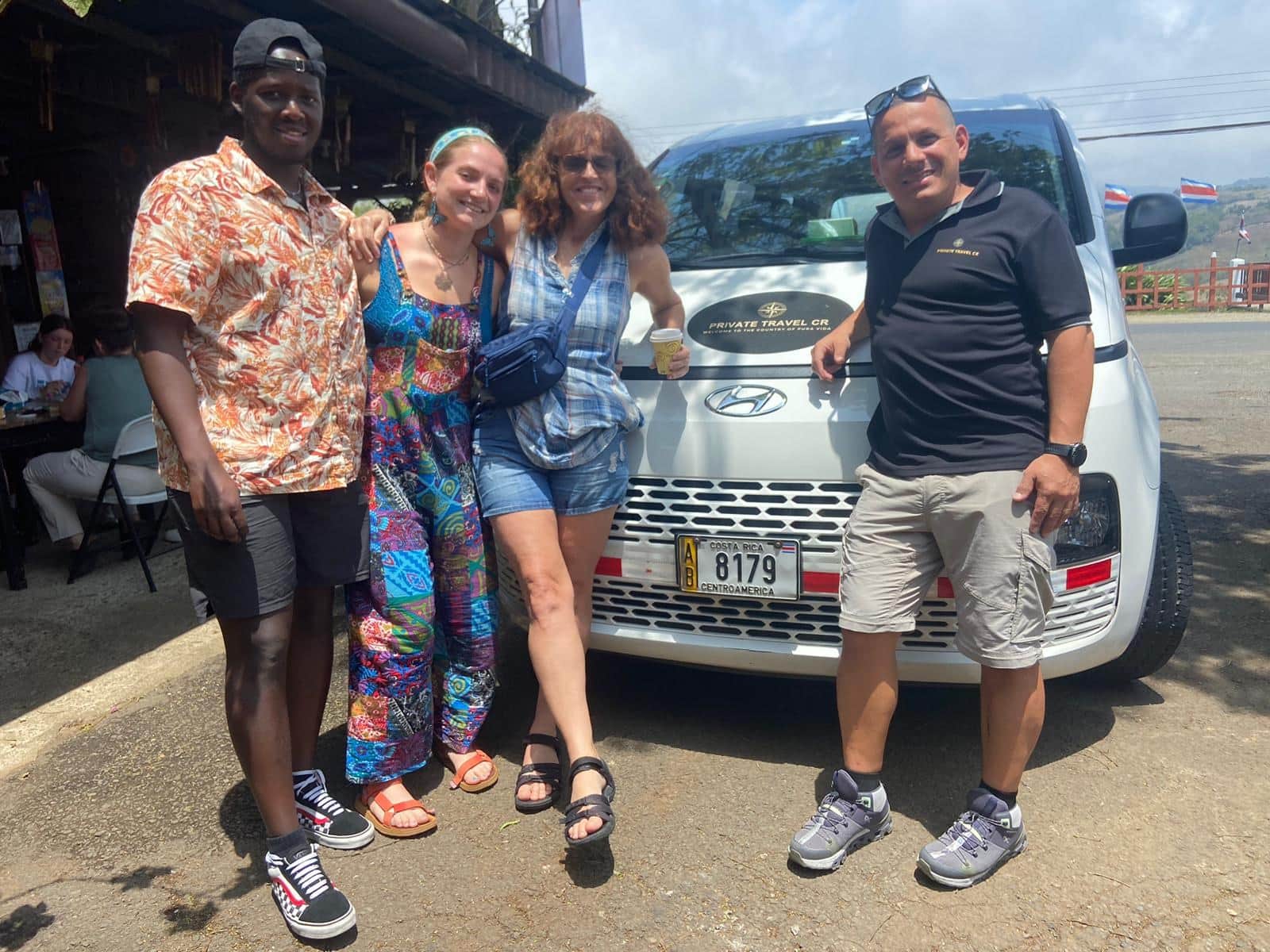 Diego with international travelers in front of the Private Travel CR van