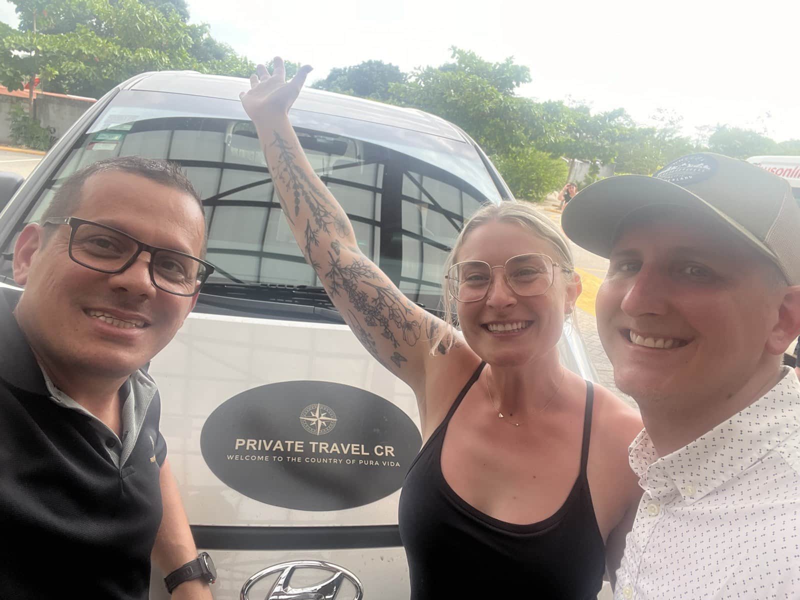 Diego with happy travelers in front of a Private Travel CR shuttle van